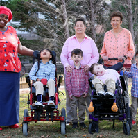 The Lyon Black family poses with their nurse Nikkie. 