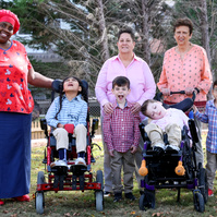 The Lyon Black family poses with their nurse Nikkie. 