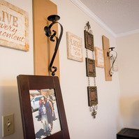 Photos sit on a table in a living room. 