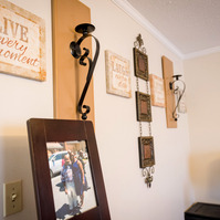 Photos sit on a table in a living room. 