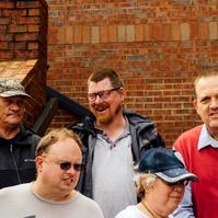 Group from the Dream Weavers stands on a brick staircase. 