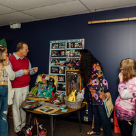 Members of the Dream Weavers stand in front of one of their art pieces. 