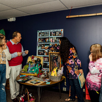 Members of the Dream Weavers stand in front of one of their art pieces. 