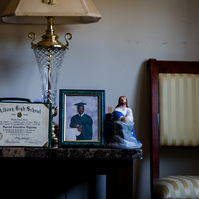 Photos sit on a table in a living room. 