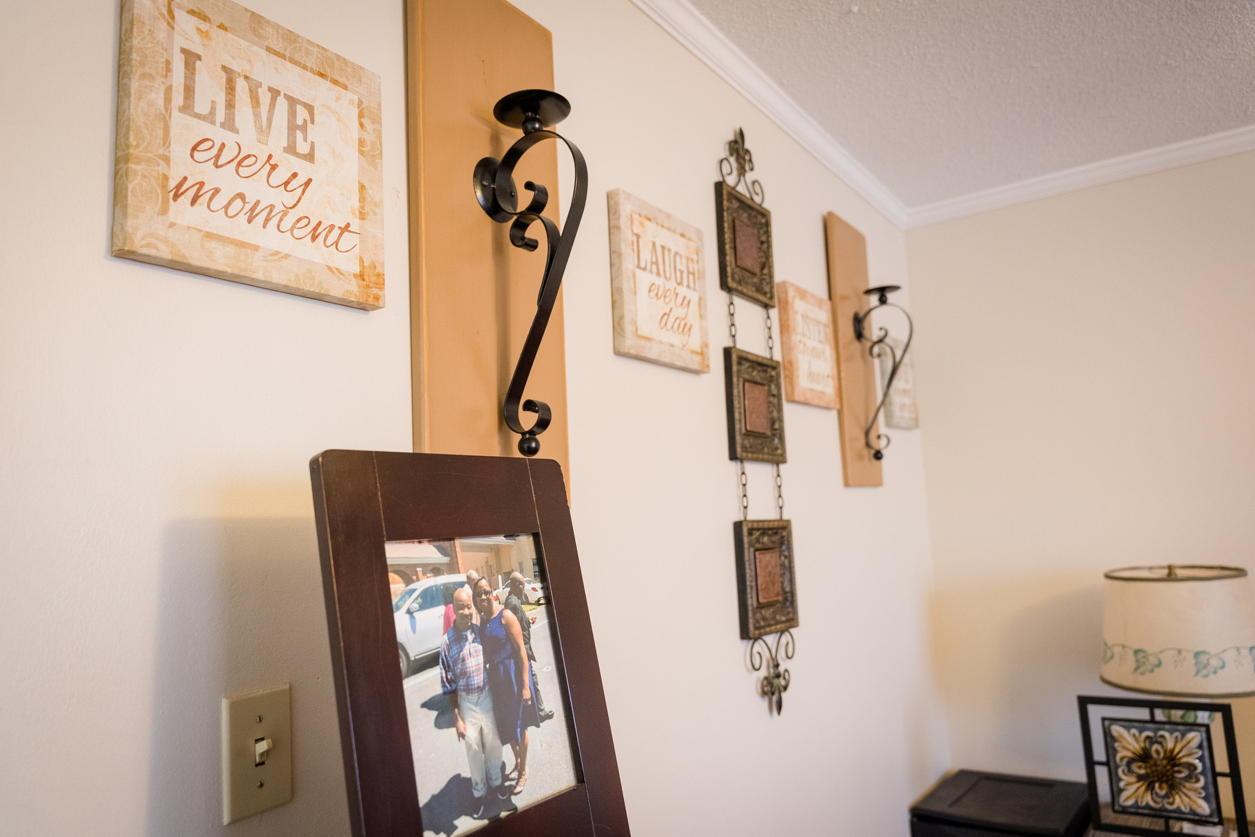 Photos sit on a table in a living room. 