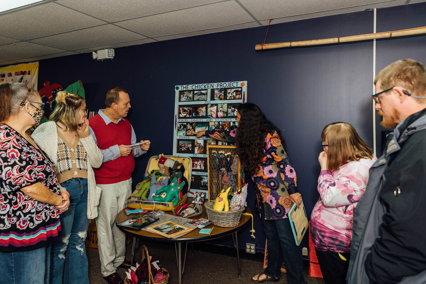 Members of the Dream Weavers stand in front of one of their art pieces. 