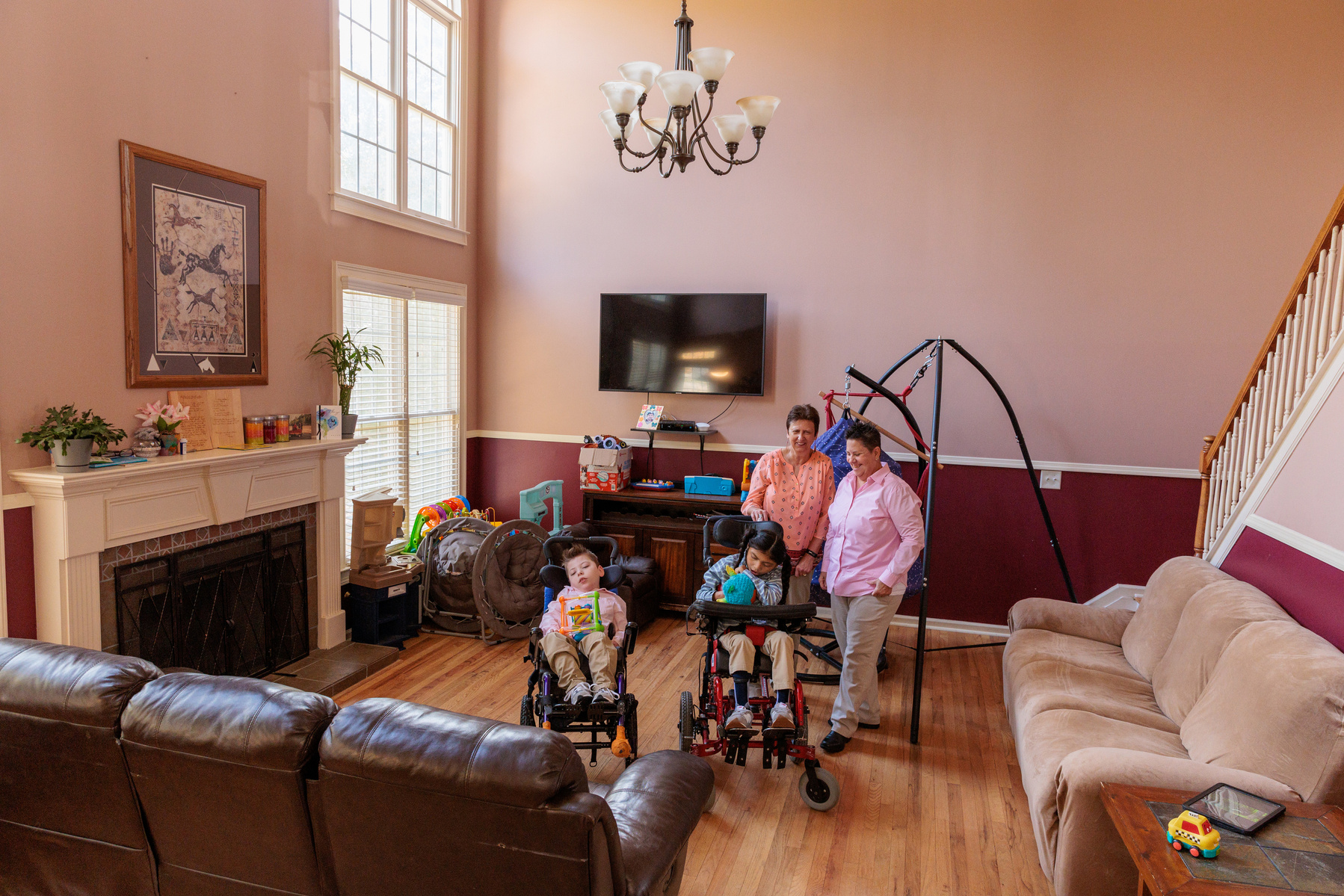 A family stands in their large living room.