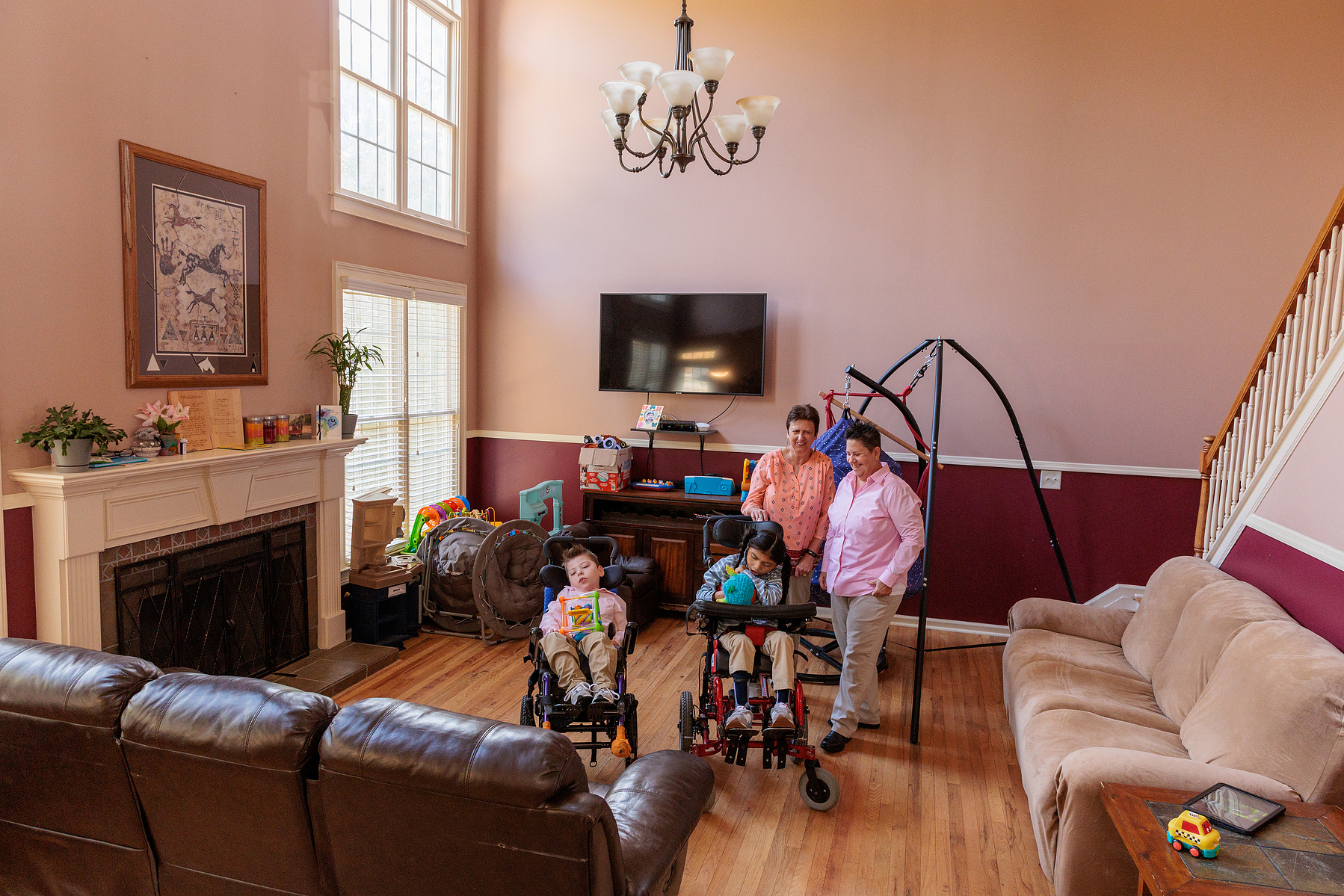 A family stands in their large living room.