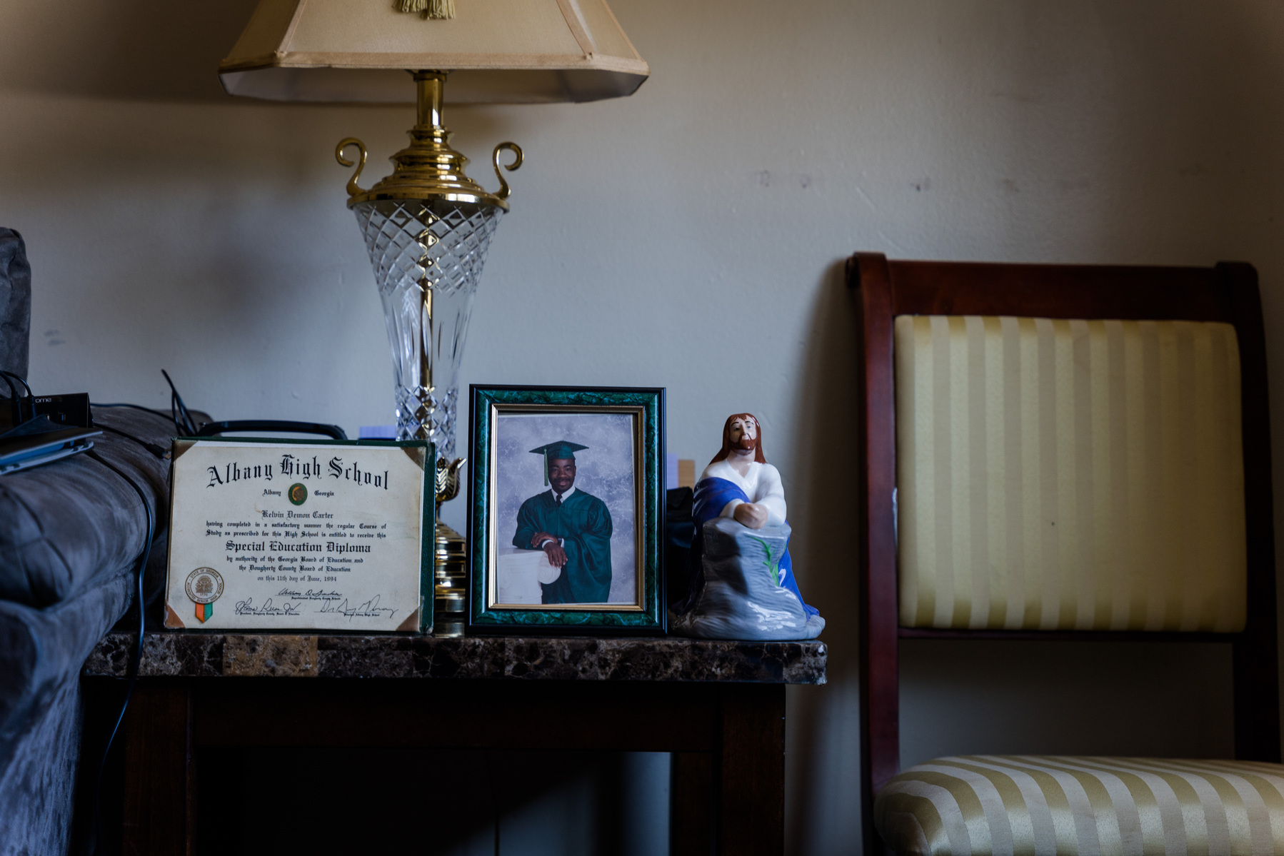 Photos sit on a table in a living room. 