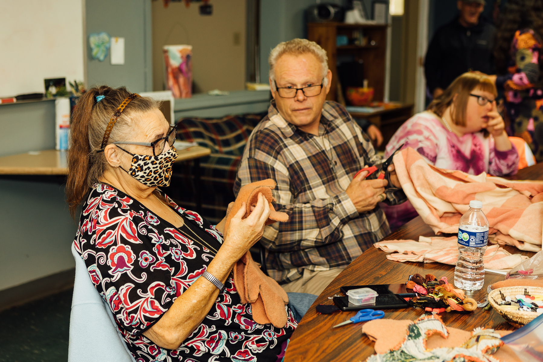 Members of the Dream Weavers sit around a table and talk. 