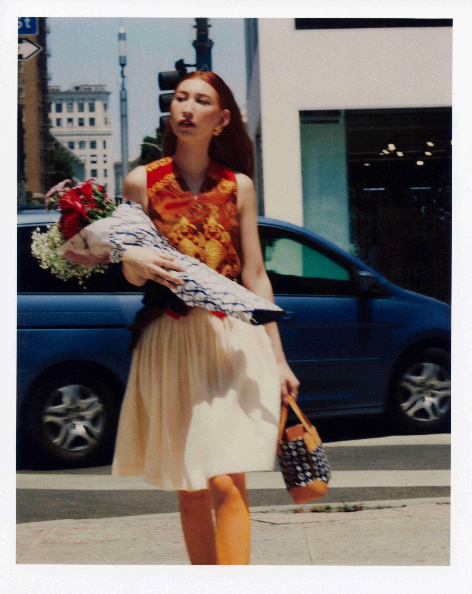 Three-quarter length editorial photo of model Clementine Callaway crossing the street during Quirk campaign shoot in Downtown Los Angeles