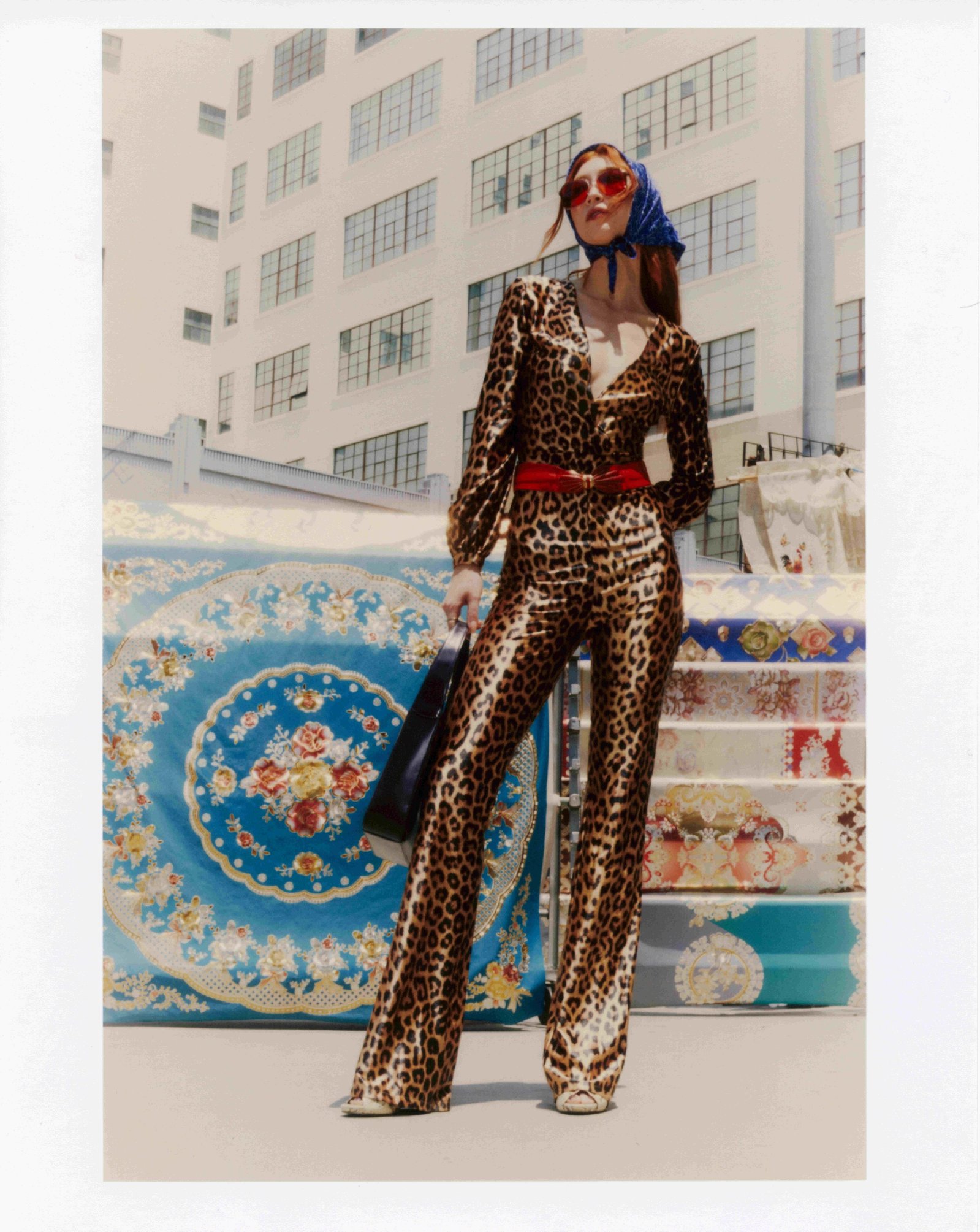 Full-length fashion campaign photo of model Clementine Callaway holding Gucci bag for Quirk clothing brand shoot in Downtown Los Angeles