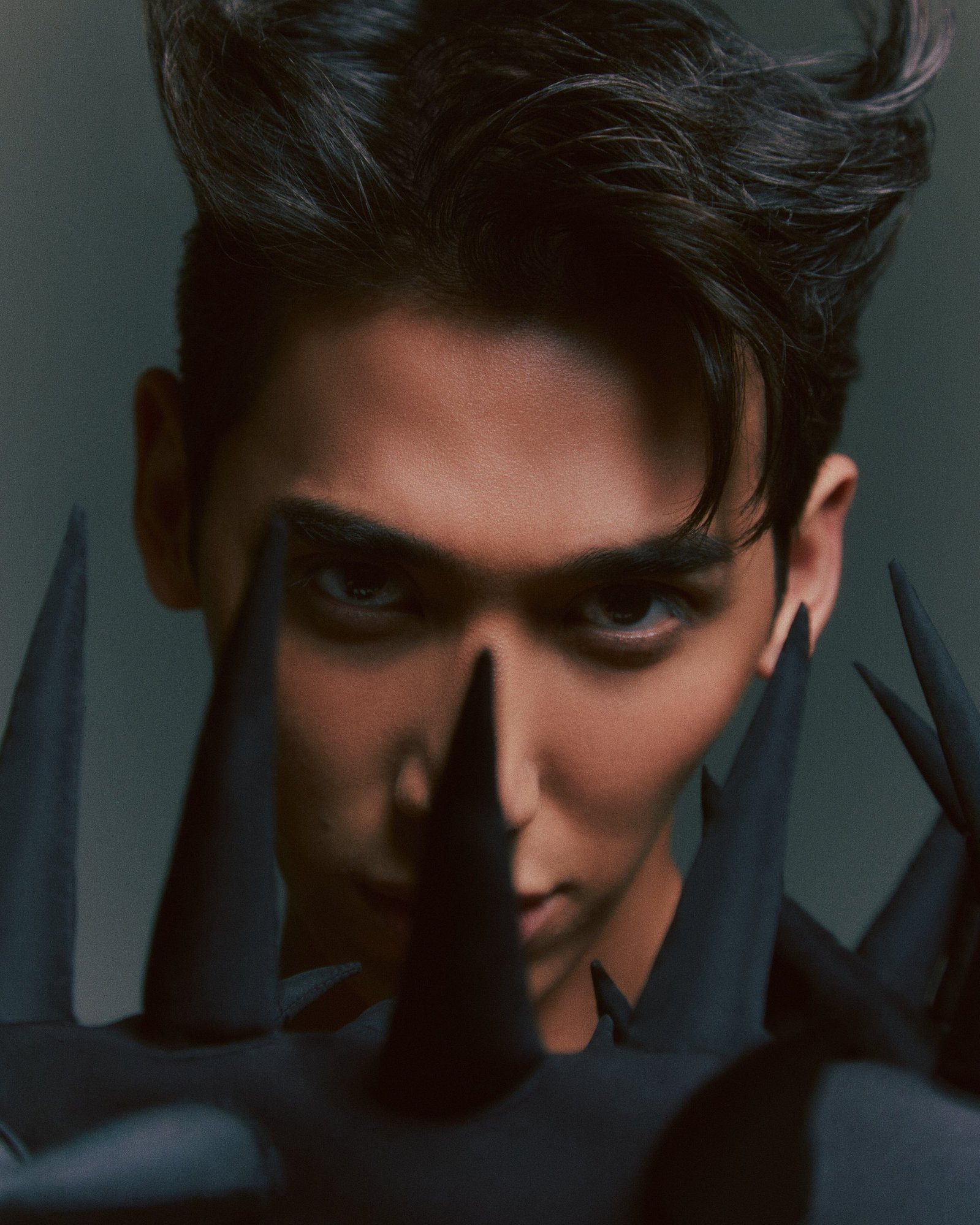 TikTok sensation and fan-favorite contestant of RuPaul's Drag Race, Vietnamese-American drag queen Plastique Tiara  out of drag, wearing a body suit featuring large black spikes, and matching spiky hair.