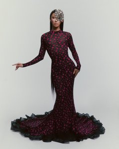 Asian-American contestant and viral TikTok sensation Plastique Tiara from RuPaul's Drag Race standing in front of a white backdrop for a fashion editorial. She wears a silver mask, black dress with fuchsia polka dots, and a silver designer mask.