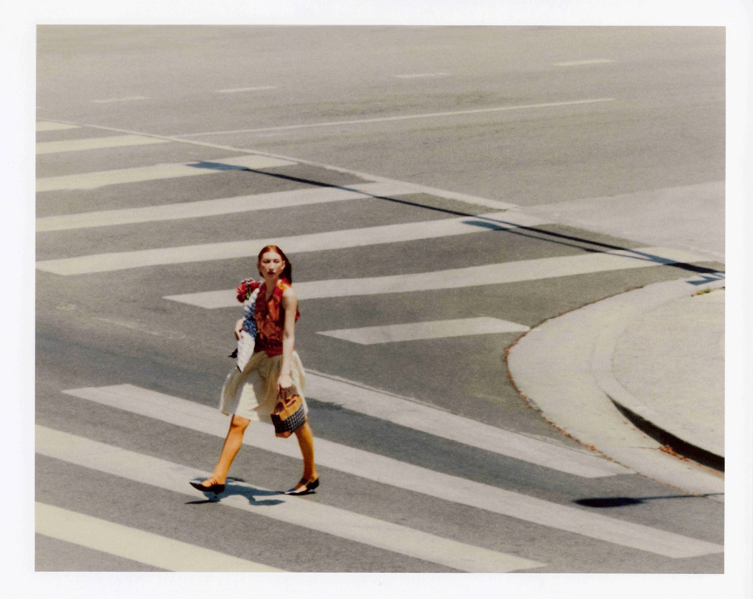 Alternate editorial street-style campaign photo of model Clementine Callaway crossing the street for Quirk clothing brand, Downtown Los Angeles
