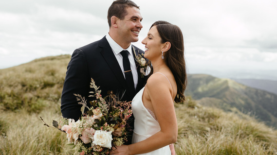 Ben May and Kirstie smiling on wedding day on mountains in Tararua Ranges, New Zealand