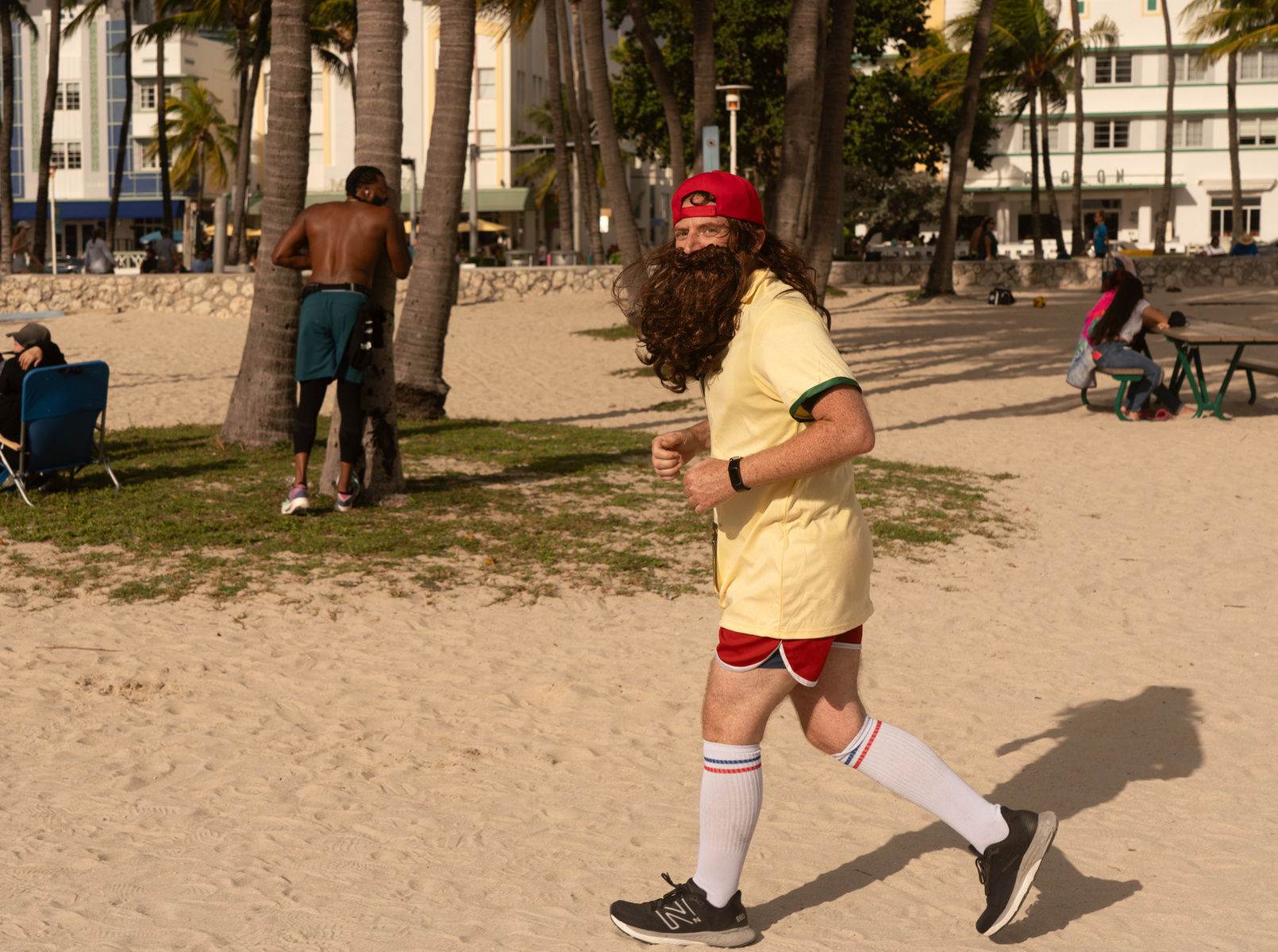 Man running in Forest Gump Beard and Red Hat