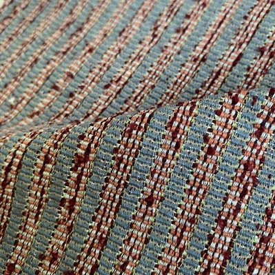 a handwoven fabric showing vertical stripes in dark red bouclé alternating with light grey and blue stripes, by Joost Post