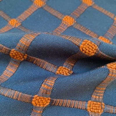 handwoven fabric made from thin blue and  thick rust coloured cotton yarns