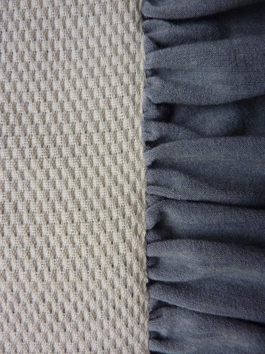 a handwoven fabric made from pure cotton with a weft of cotton tricot fabric that is still visible at the edge as a ruffle, by Joost Post