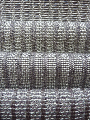 set of four handwoven fabrics made from silver grey polyester and shiny mint green polypropylene by Joost Post
