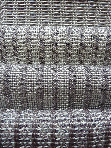 set of four handwoven fabrics made from silver grey polyester and shiny mint green polypropylene by Joost Post