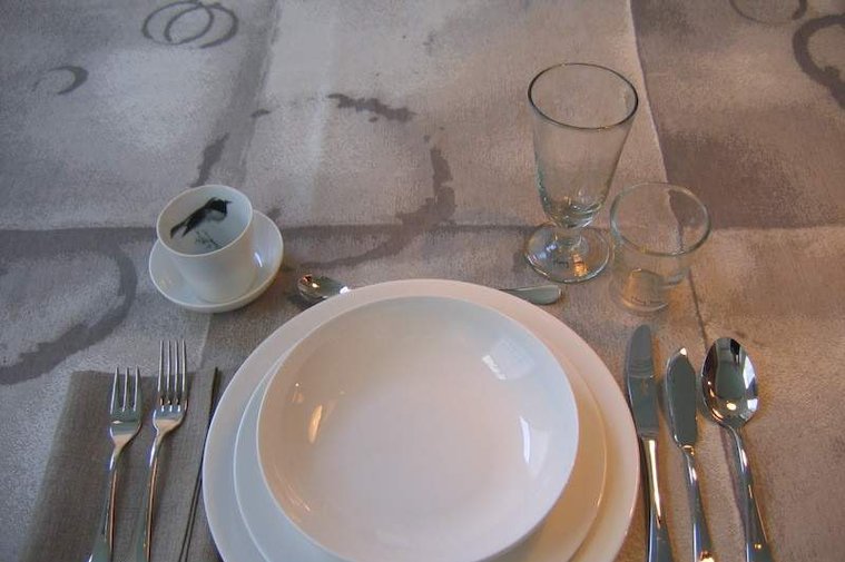a jacquard woven table cloth depicting folds and imprinted stained circles in cotton and linen, by Joost Post