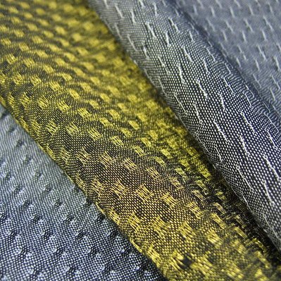 handwoven fabrics made from polyester, metal yarn and titanium film by Joost Post