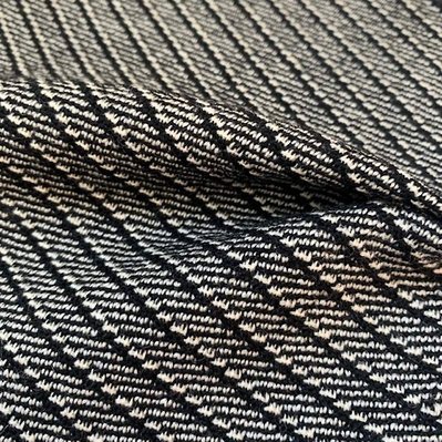 handwoven fabric in pure wool with a diagonal black and white striped pattern by Joost Post