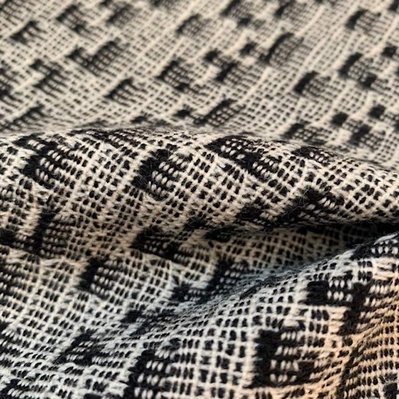 handwoven woolen fabric with a rather complex black and white pattern by Joost Post