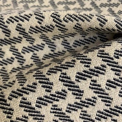 handwoven woolen fabric with a diagonal pattern of interlacing stripes by Joost Post