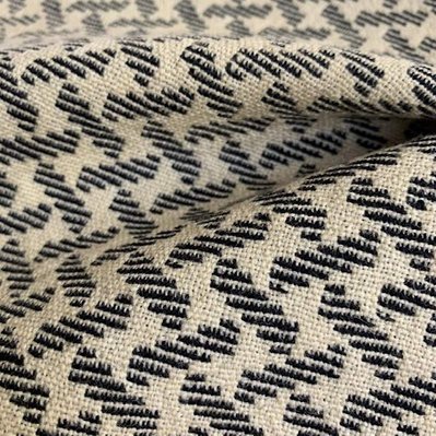 handwoven woolen fabric with a diagonal pattern of interlacing stripes by Joost Post