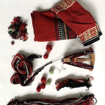 A dismantled cardigan, partly unraveled.