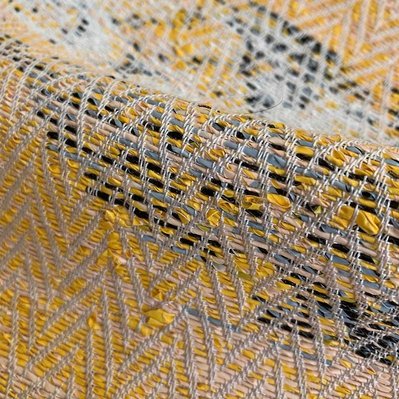 a handwoven fabric made with a handspun yarn that was made of  recycled plastic bags, by Joost Post