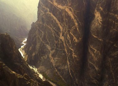 Painted Rock with fire smoke at The Black Canyons of the Gunnison National Park, CO