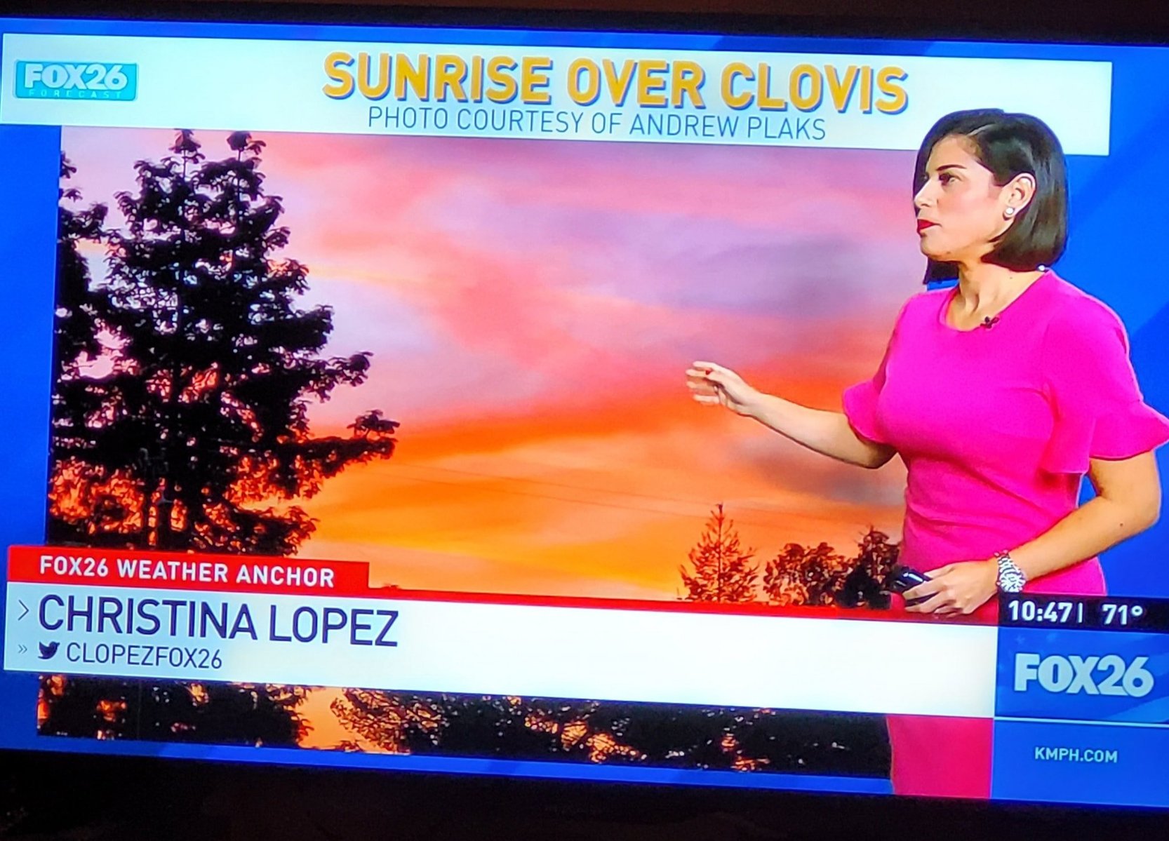 Newscaster gesturing over photo of sunrise. Text above reads: Sunrise over Clovis Photo Courtesy of Andrew Plaks