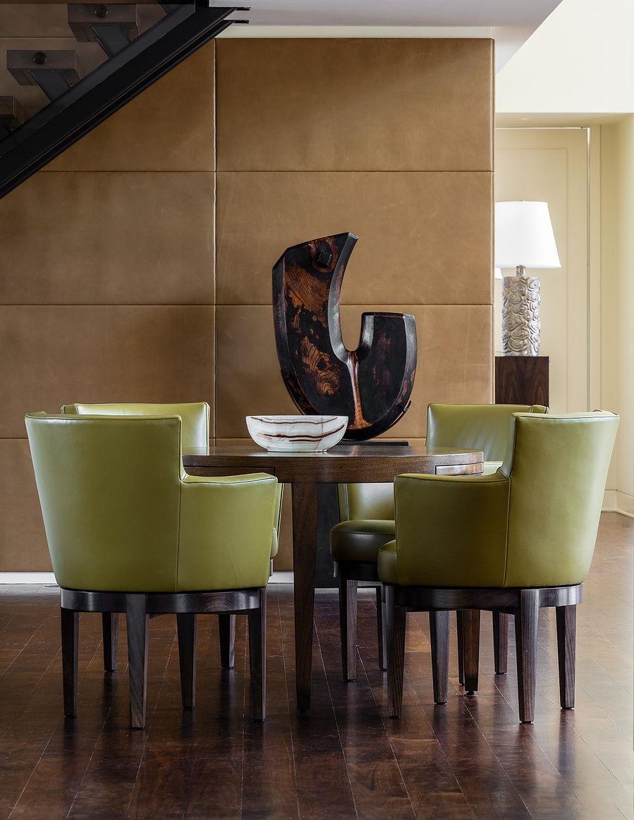 a dining table with 4 green chairs