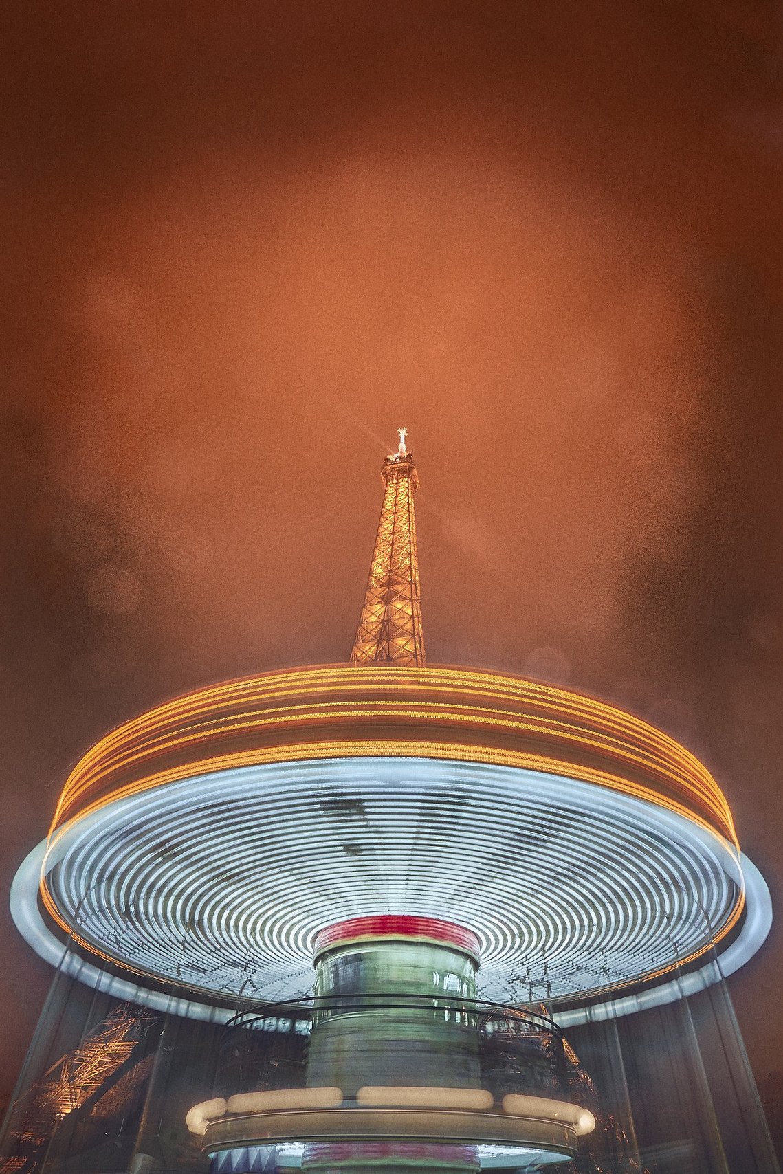 A drizzly night as a merry go round whizzes by the Tower we've all seen before