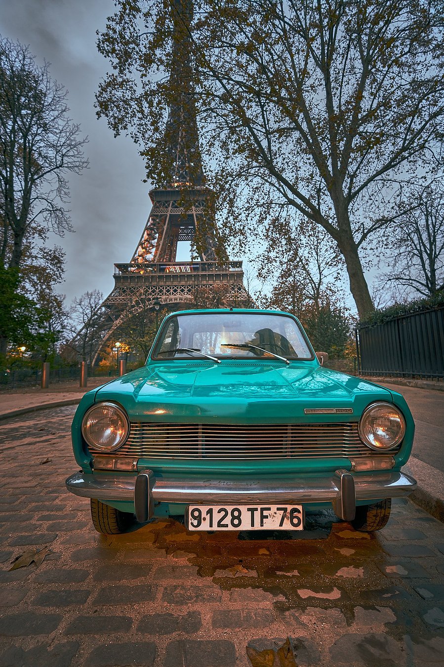A sports car in front of the eiffel tower