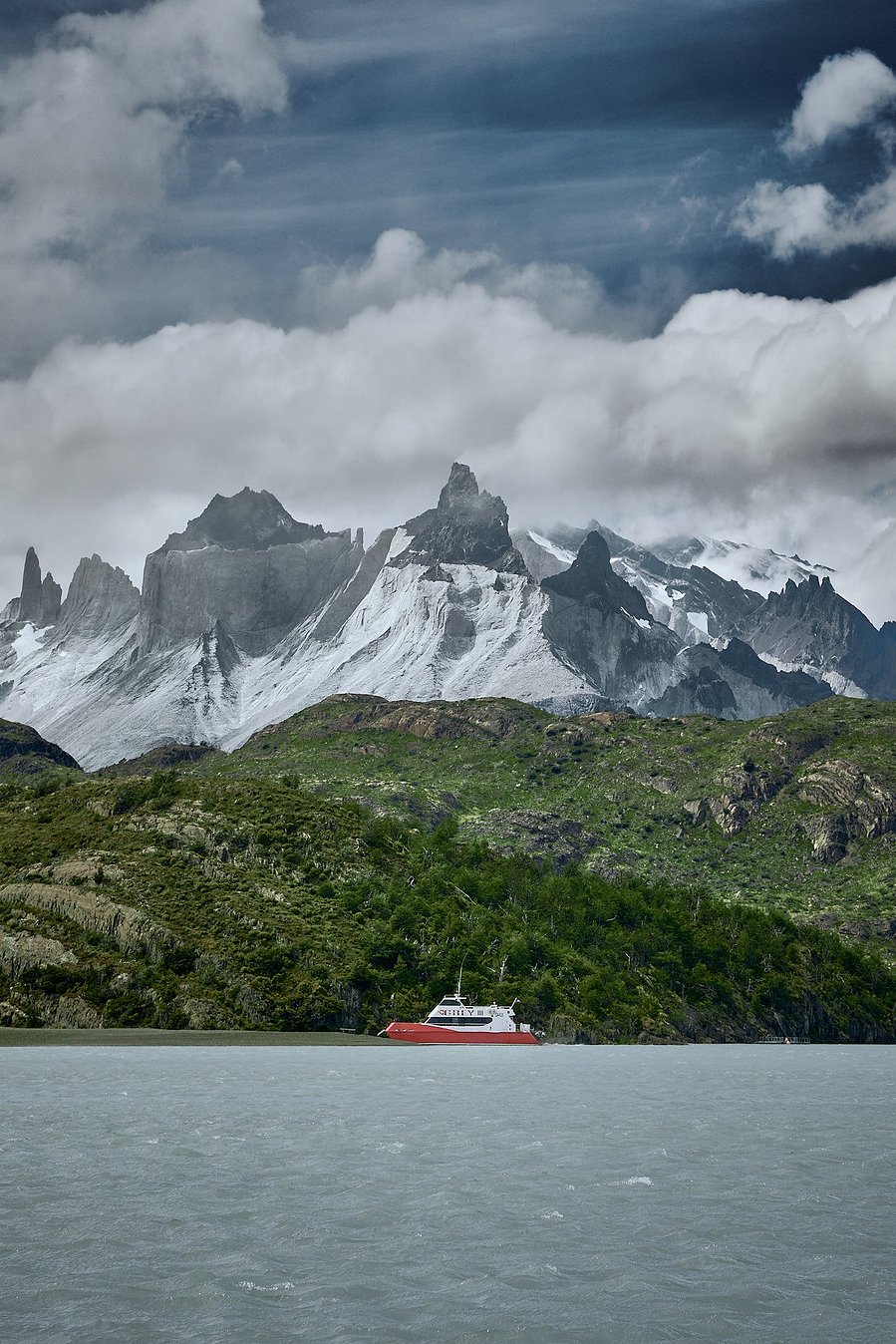 Cuernos mountains with a boat in front on lago grey, patagonia