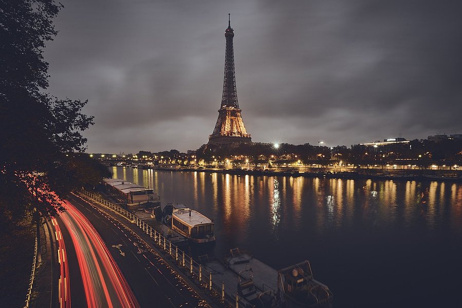 The Eiffel Tower at night with the Seine