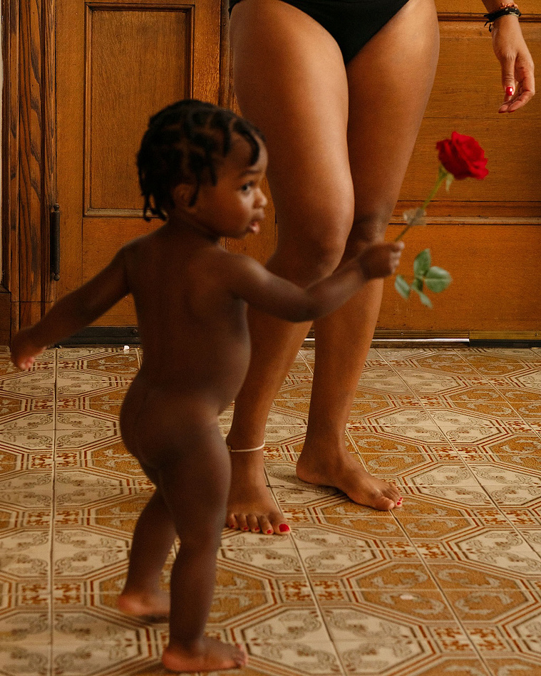 black woman with her son and a red rose