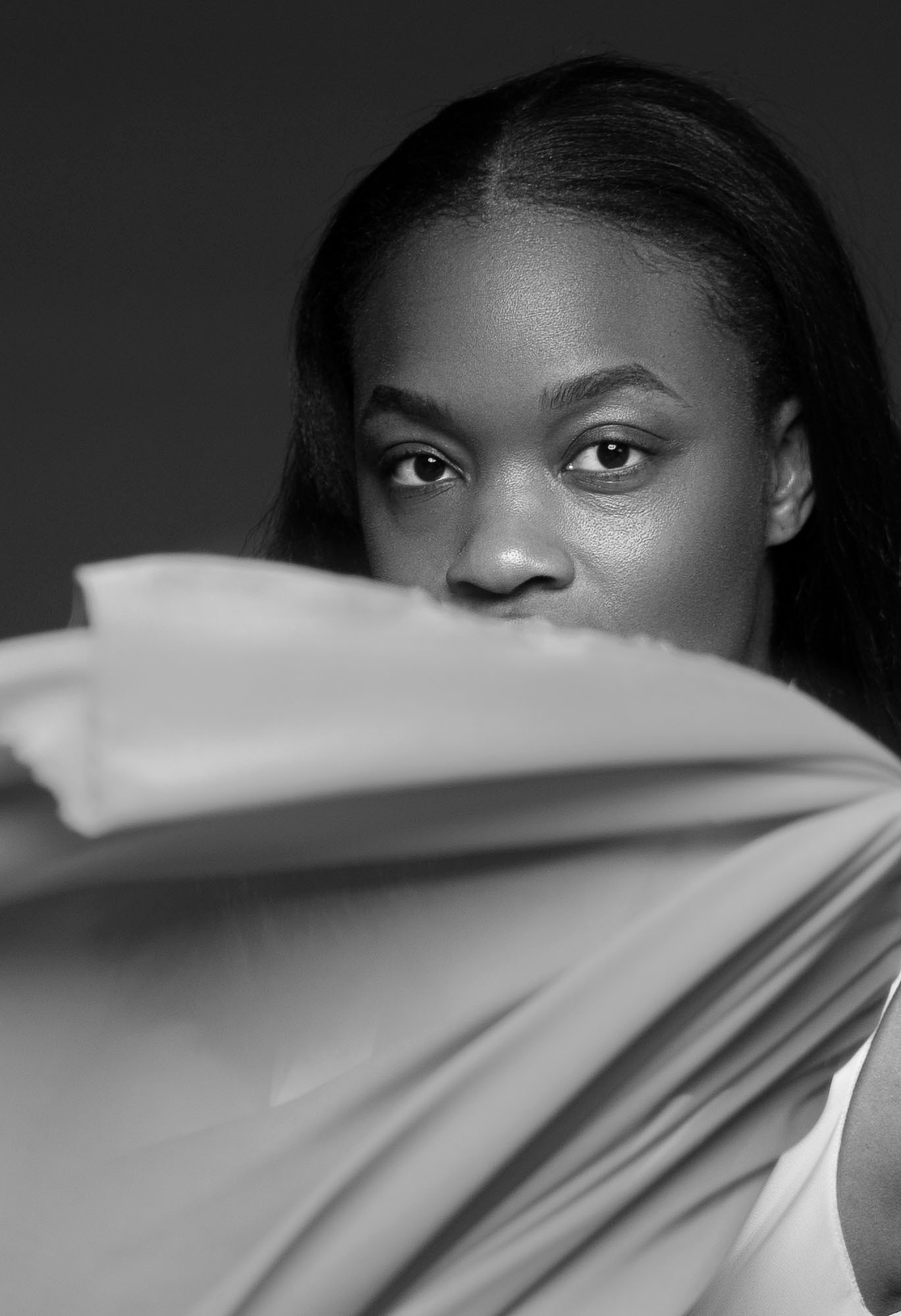 black woman with a thin sheer cloth hiding her lips