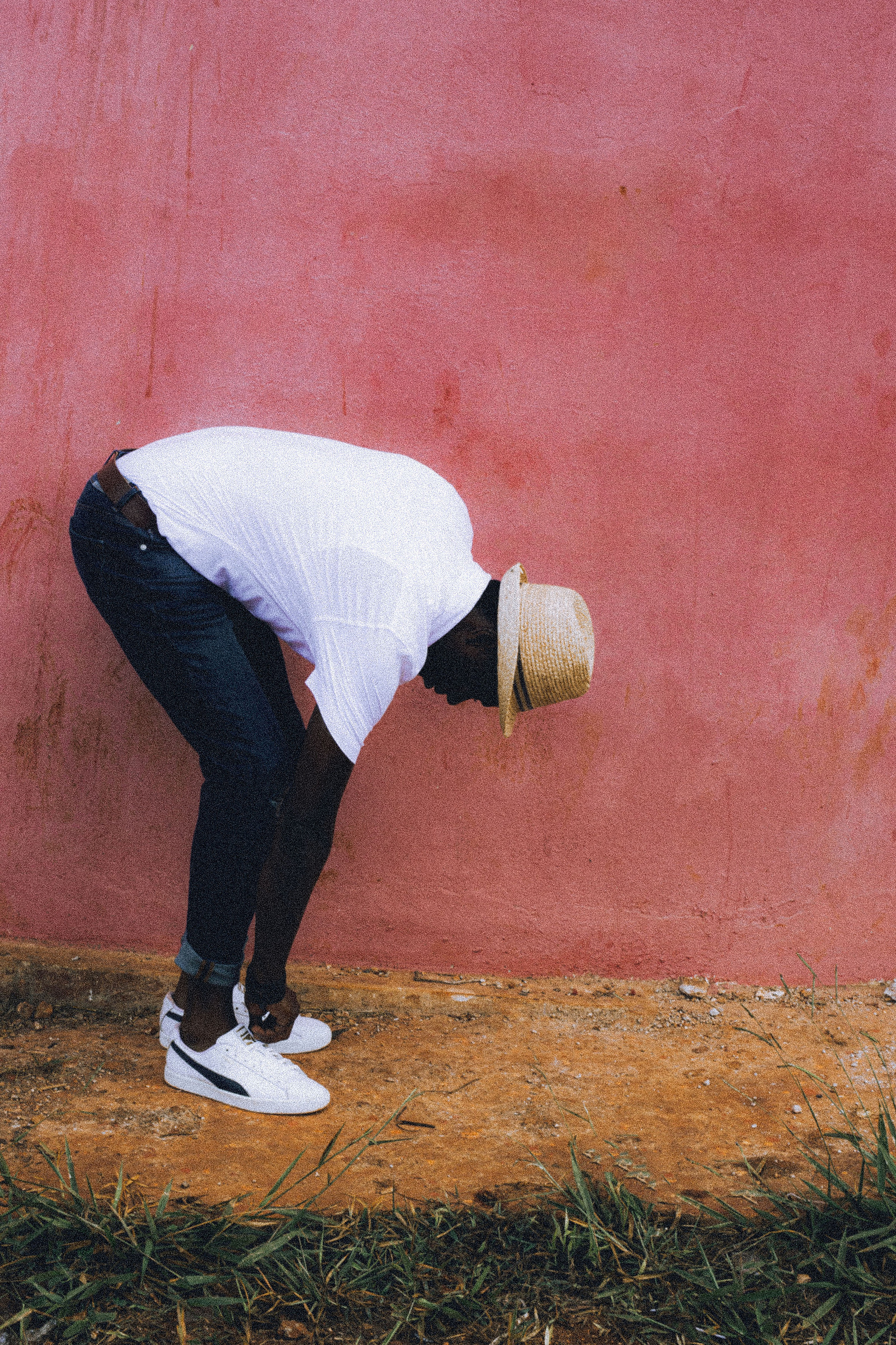 black man fixing his shoes