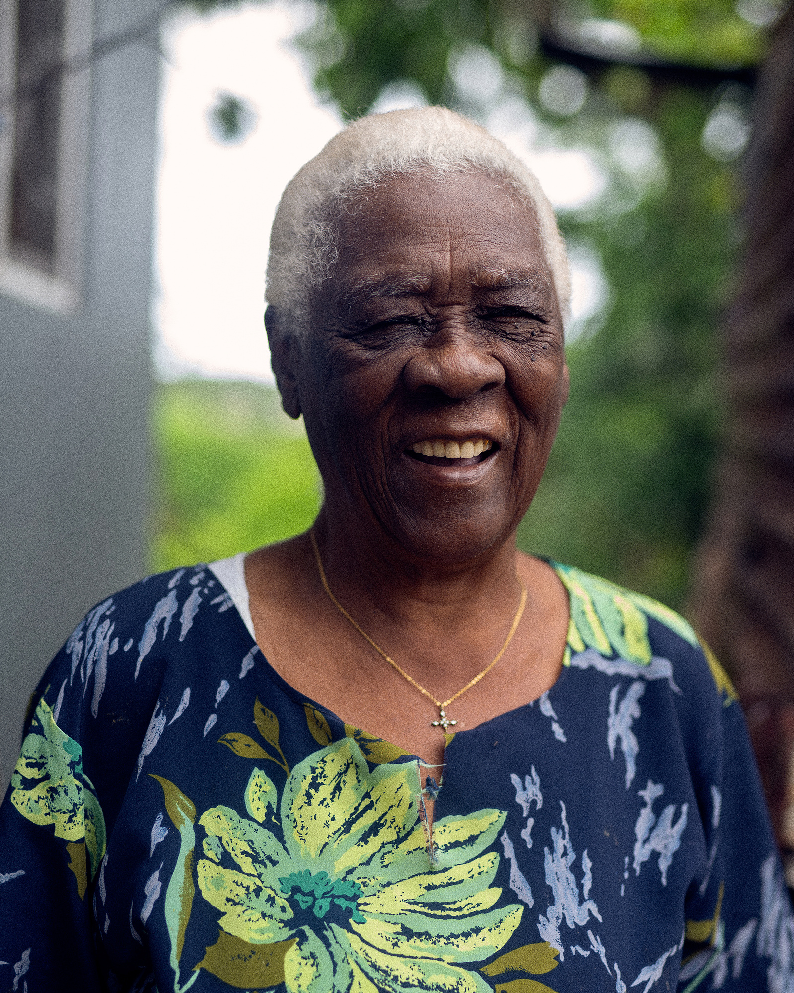 Elderly Jamaican woman with white hair smiling