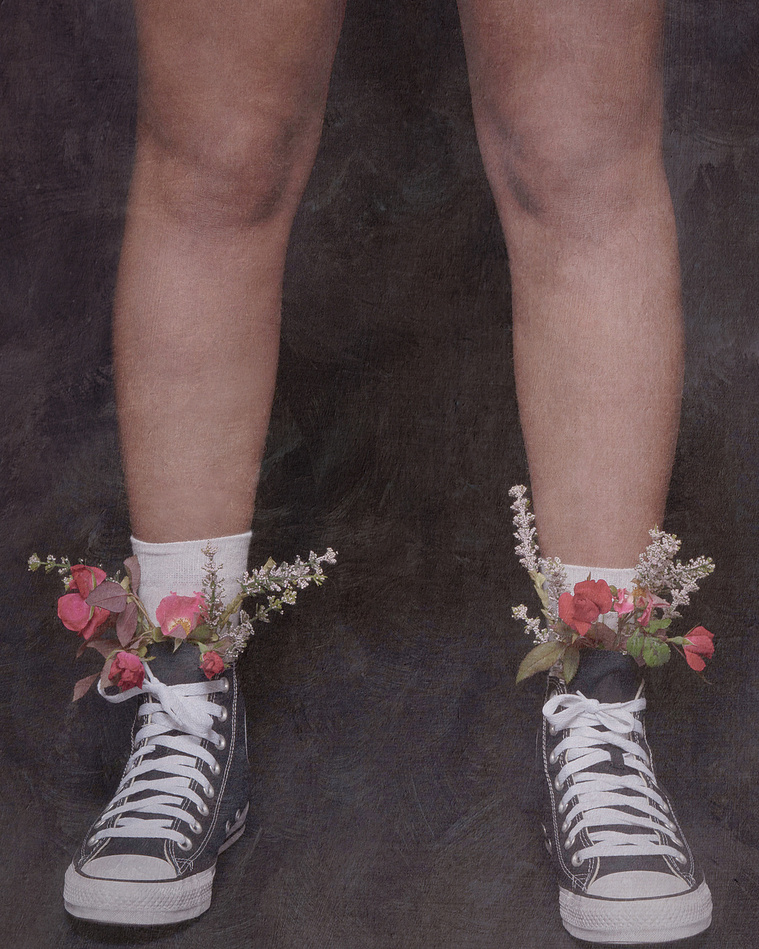 feet wearing converse with flowers growing out of it