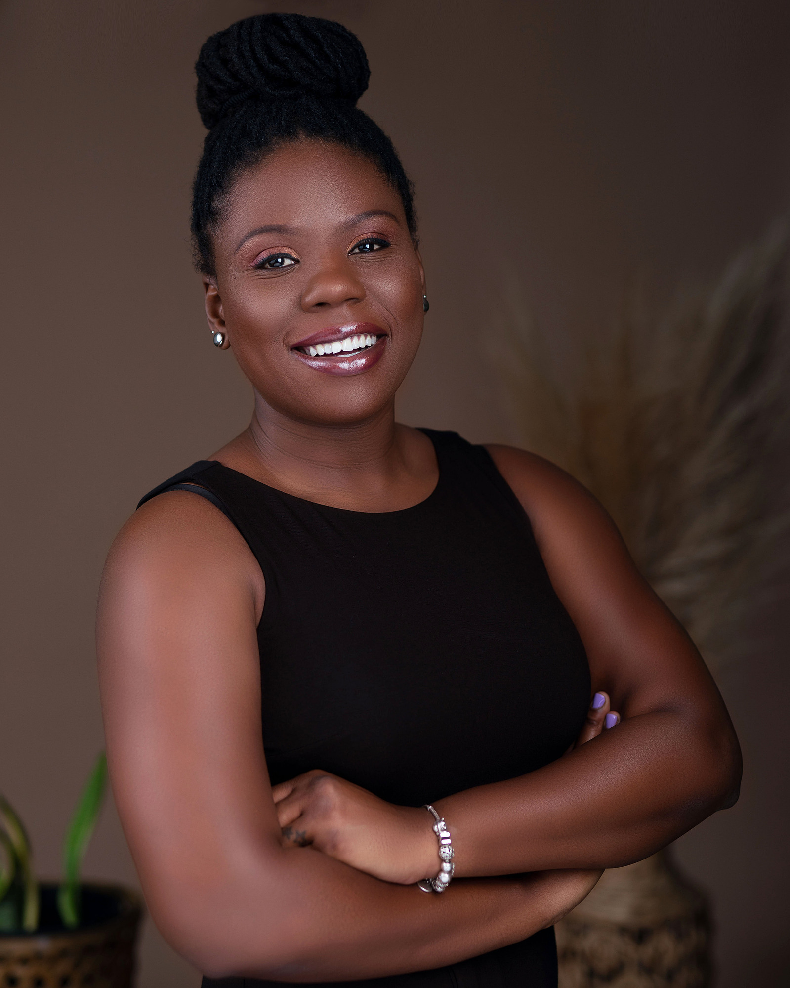 black female journalist wearing a black top