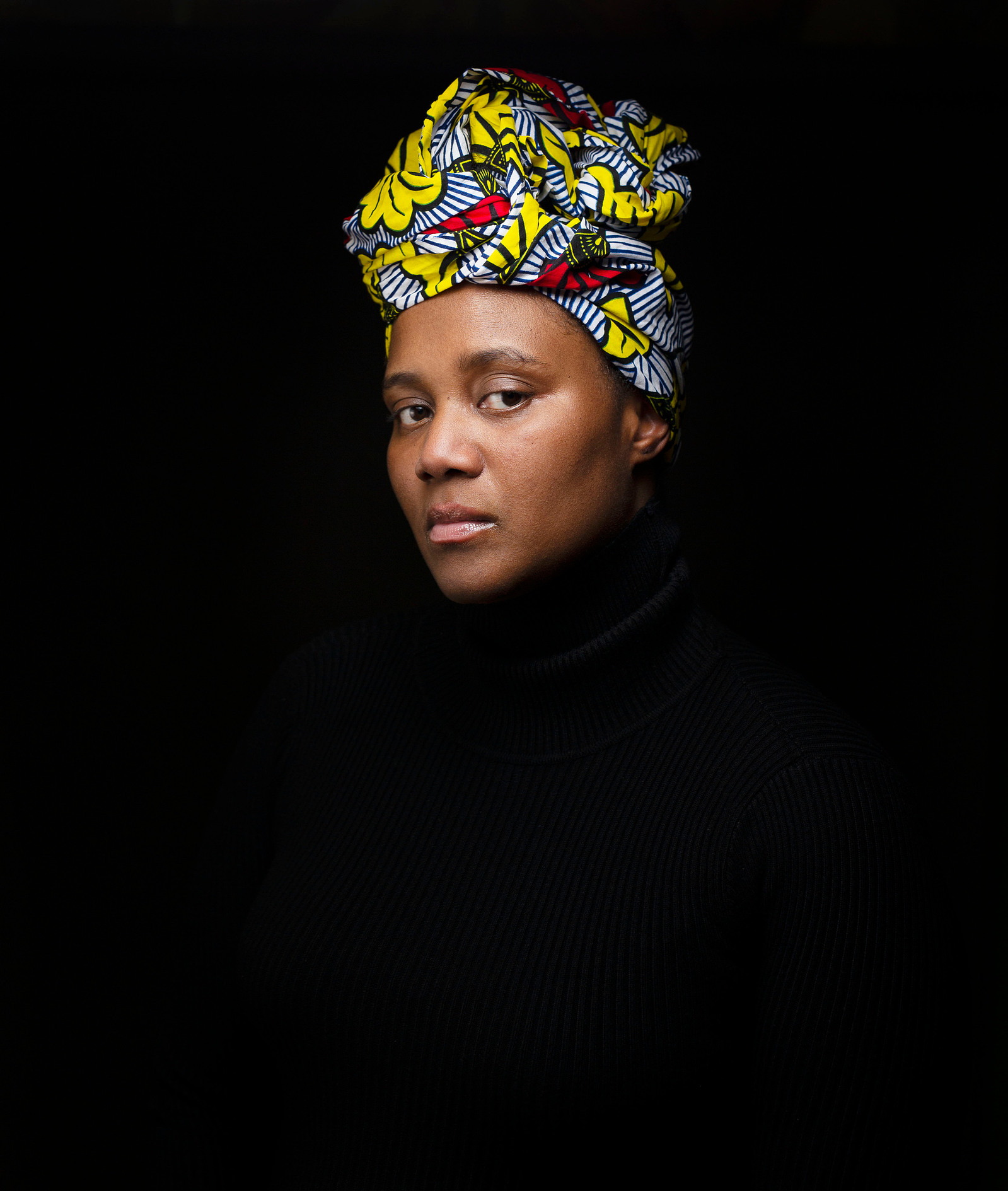 black woman with head wrapped in african print cloth
