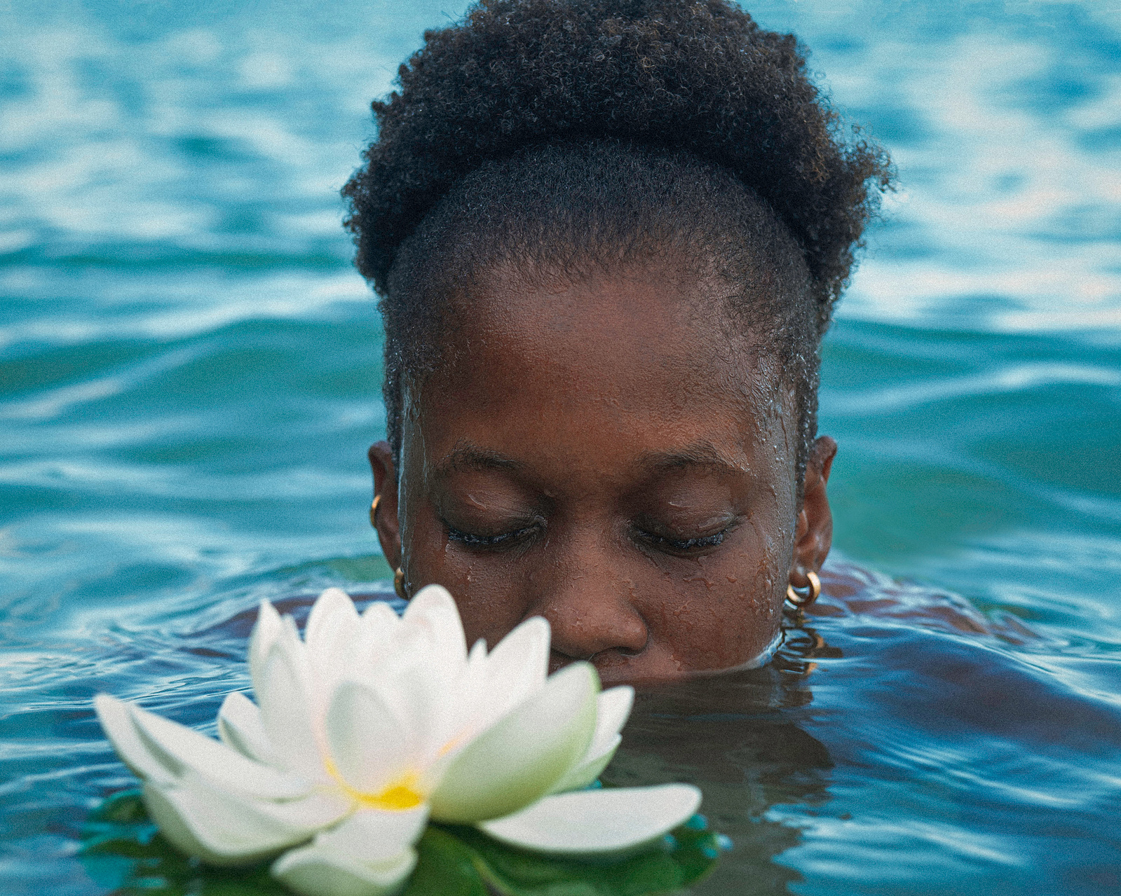 Wall art with Lilly and a woman partially submerged in a body of water