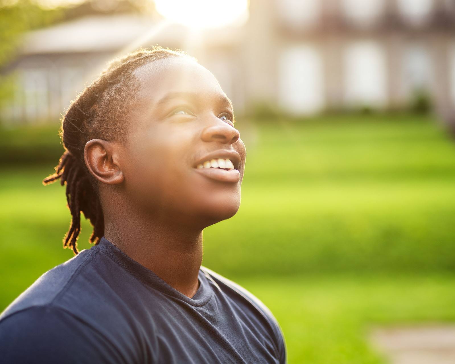 black man with locs looking towards the sky